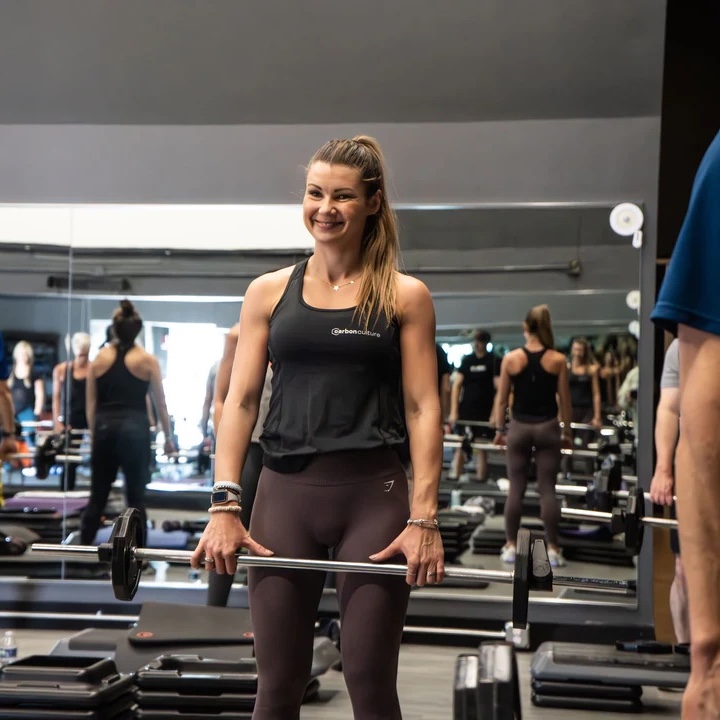 Classes-BodyPump fit woman holding barbell during group fitness class at carbon performance gym in nashville tn and franklin tn