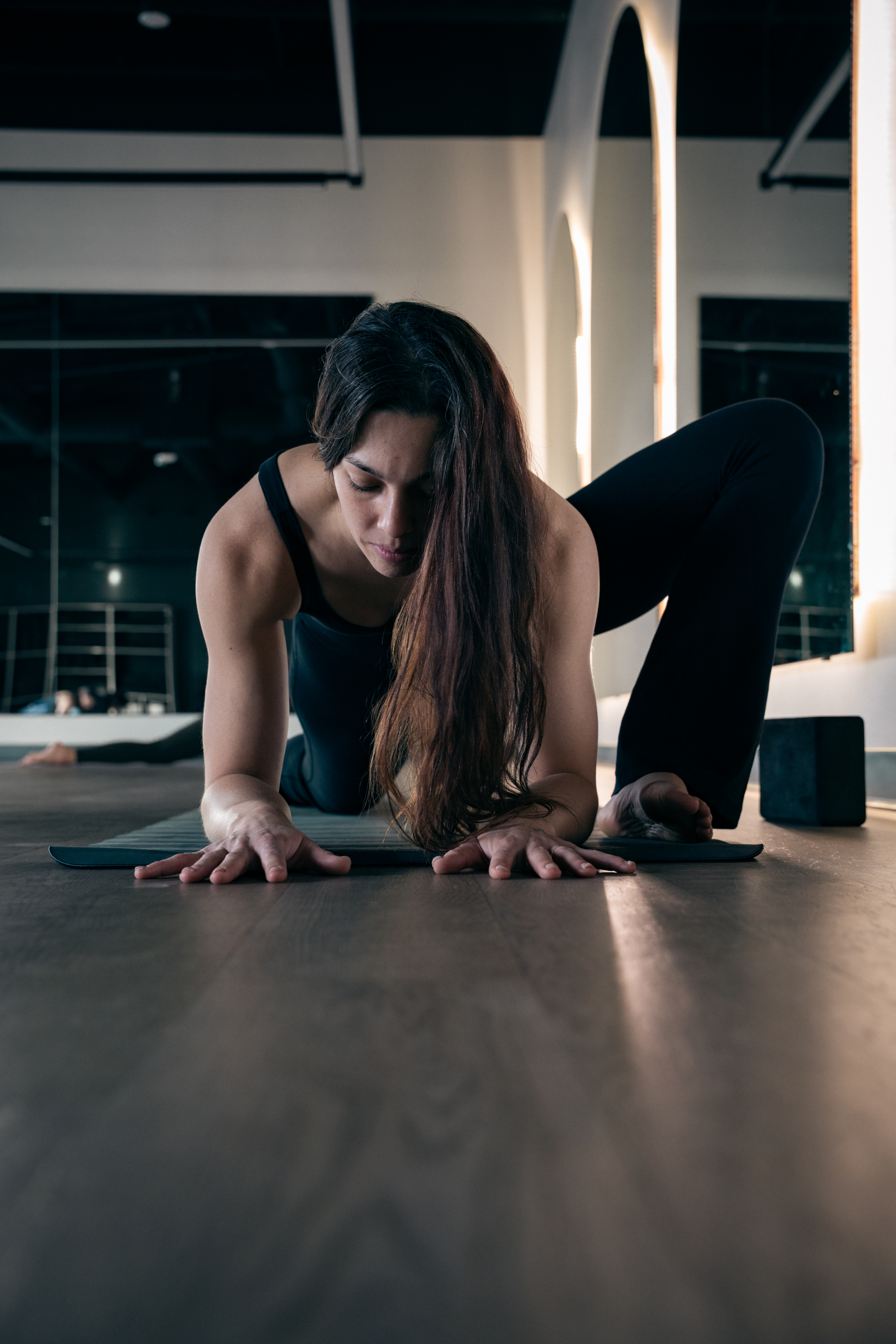 Woman stretching during yoga Yoga Sculpt at Carbon Performance