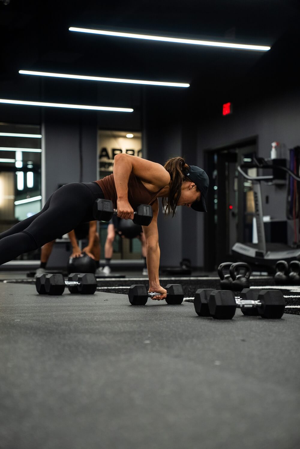 Carbon – February Edge Class-44 A woman lifting weights at Carbon Performance in an Edge Class