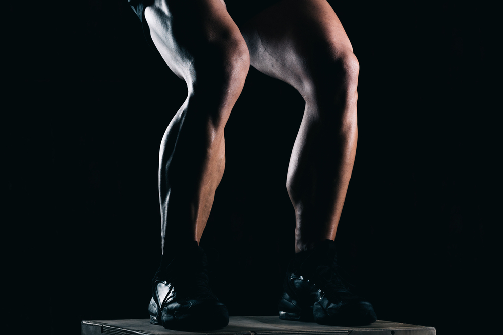 Photo of man's legs as he does leg exercises at the gym