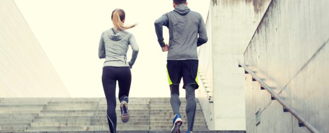 couple running up stairs early in the morning for their fitness routine
