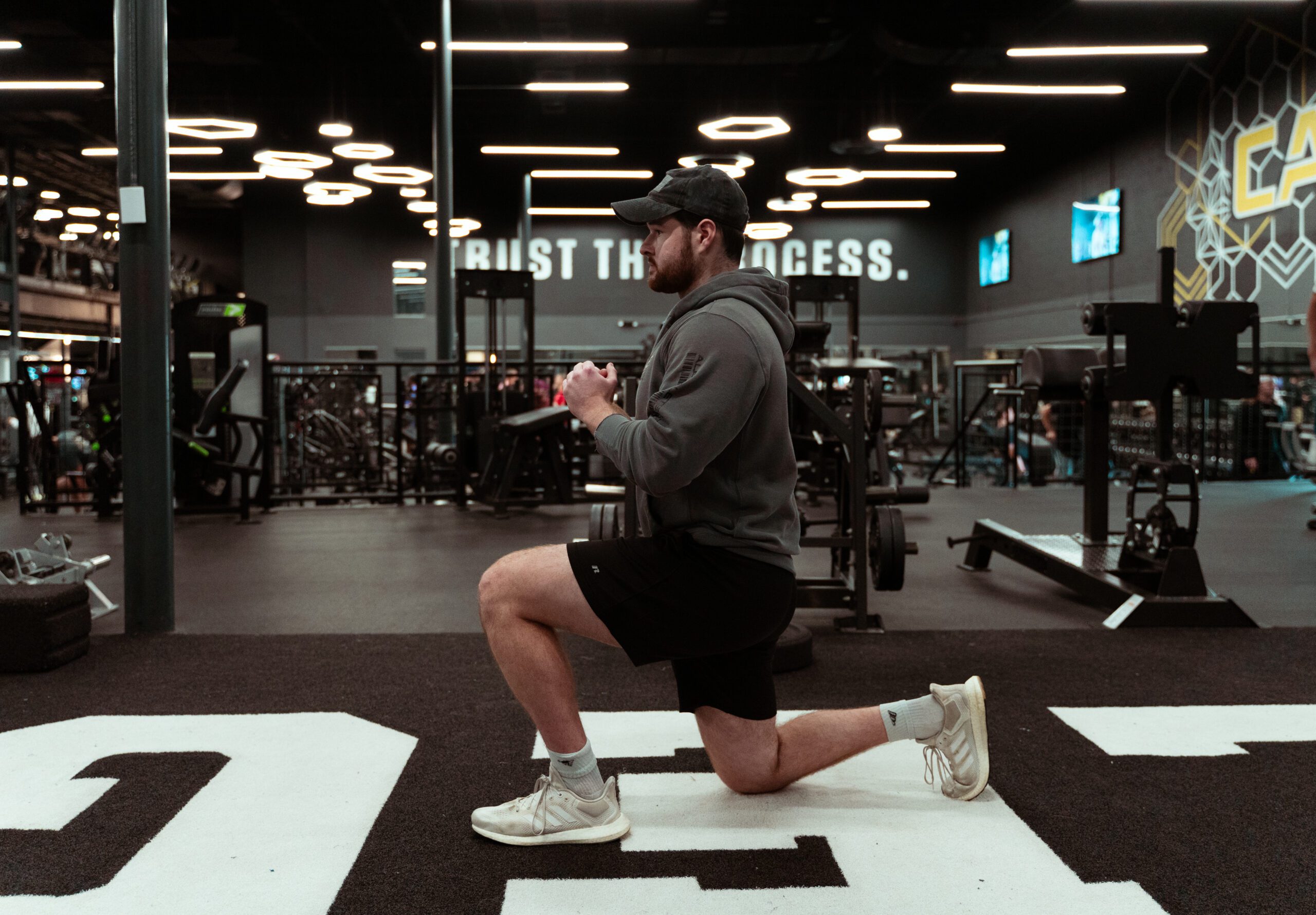 Man performing a back lunge in gym