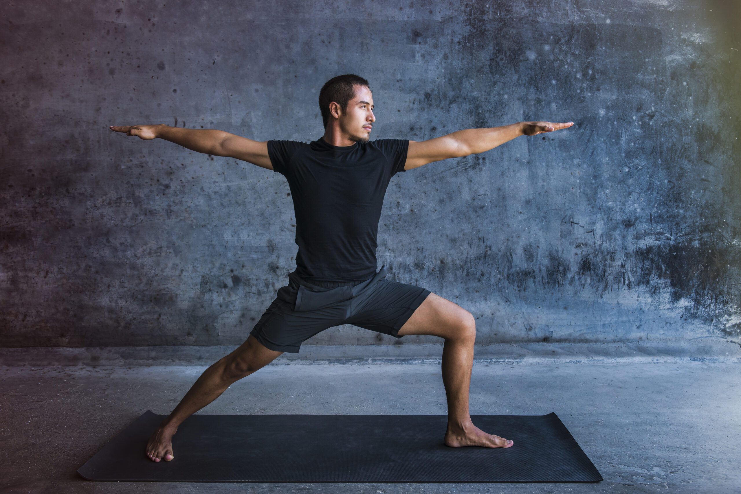 Man performing yoga pose on mat.