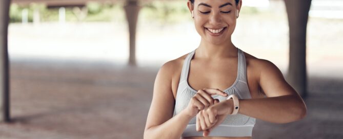Athletic woman checking smart watch.