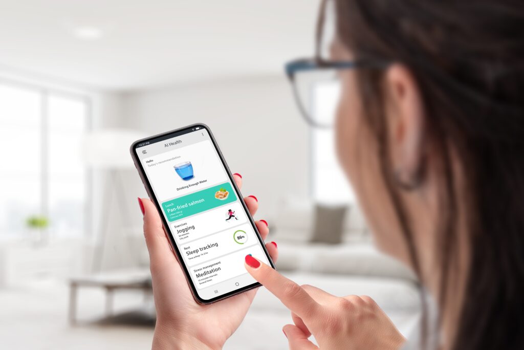 Woma looking at AI app on phone tracking fitness and health.