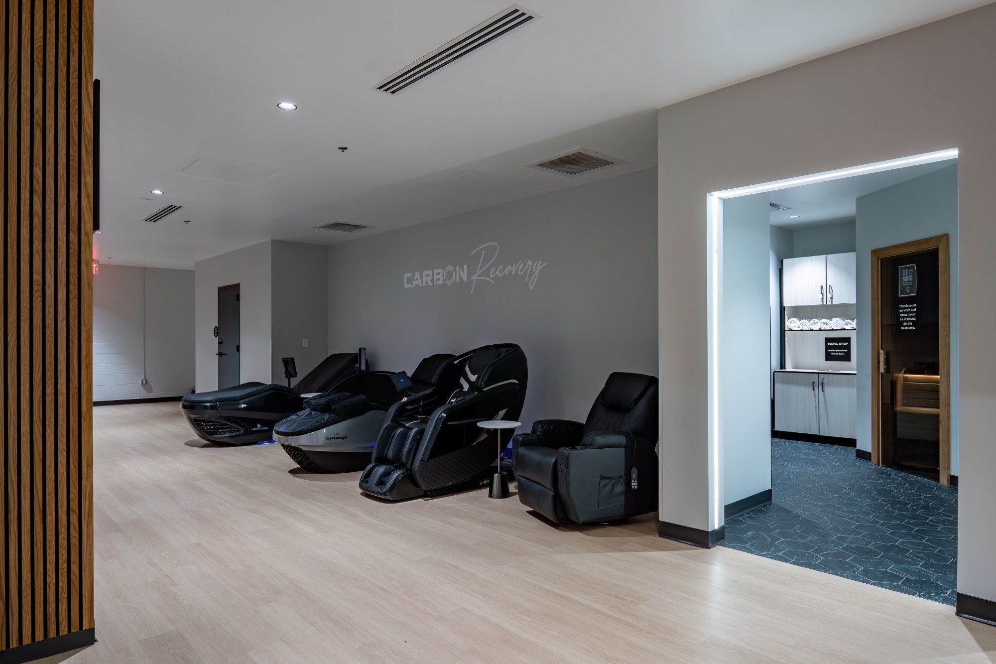 Carbon Recovery lounge with massage chairs and compression recovery stations